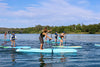 12'6 Kids Race SUP Paddle Board designed specifically for children.  Kids getting ready for a kids sup race event paddling from left to right towards the starting line with a bridge in the background