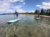2 boys paddling on their kids paddle boards.  The waterkids 7'6 and 9'6 paddle boars are great for kids ages 4 - 14 years old and can even be used by experienced adults.  Kids having a good time on the lake laughing and smiling while padding around