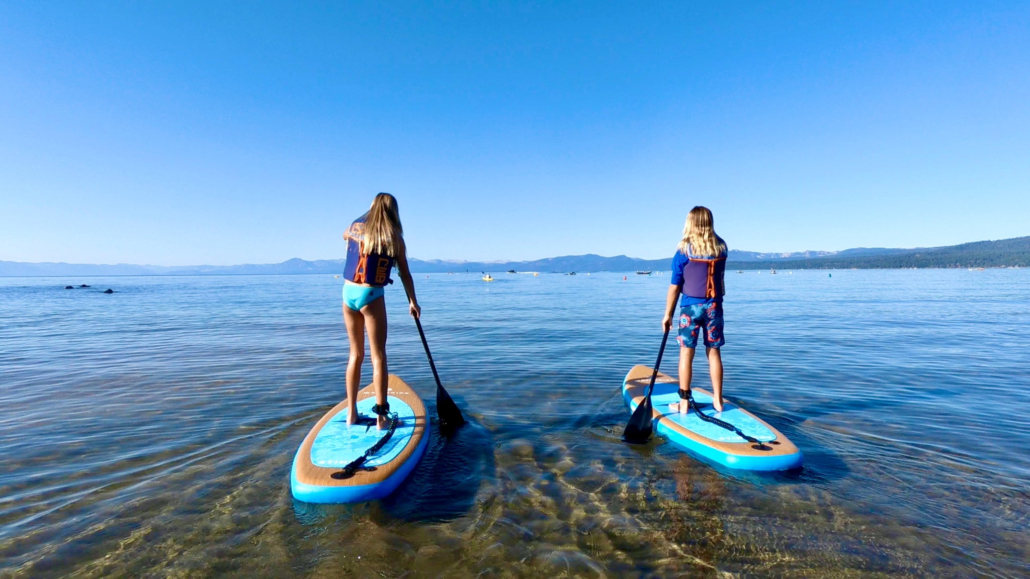 youth children paddle board together on lake tahoe sup for kids