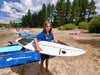 Boy at the beach with his fiberglass surfboard for kids made for high performance wave surfing and barrel riding