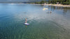 Drone shot of a young girl about 10 years old paddling on lake Tahoe.  Great picture of a girl in the morning with no one else around and calm water paddleboarding on her waterkids 8ft lotus purple color kids paddle boards designed for women and girls.