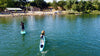 Boy approaching the finish line of his kids sup race on his waterkids tahit pro carbon fiber race paddle board for kids