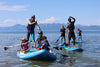 kids & children paddle boarding on the lake.  Kids camp & water school out for a day at lake tahoe with parents