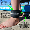 Coiled SUP leash for kids that is padded for extra comfort.   Waterkids ankle leash adjustable to fit kids of all sizes and ability levels.  Leash provides safety so if you fall off your paddleboard you will remain close to the board.  It is built with a grab loop to easily put the leash on and off and a padded velcro strap for easy attachment .  Boy standing in the sand wearing a paddle board ankle leash.